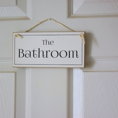 black and white bathroom sign on a door