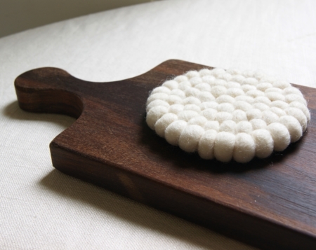 wood board and cream wool coaster