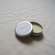 metal tin lip balm with mimosa on the label