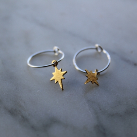 silver hoop earrings with brass polar star drops